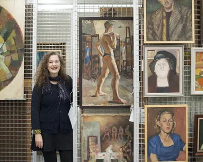 Deborah Beck in NAS Archives with paintings from the NAS Collection scaled