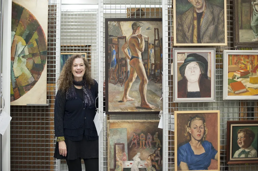 Deborah Beck in NAS Archives with paintings from the NAS Collection scaled